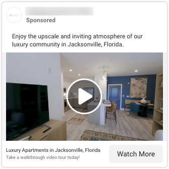 Screenshot of a Facebook video ad showing a stylish apartment interior with an open-concept layout. A TV sits on a wooden console opposite a cozy seating area. The space leads into a kitchen with pendant lighting, bar seating, and a blue accent wall.