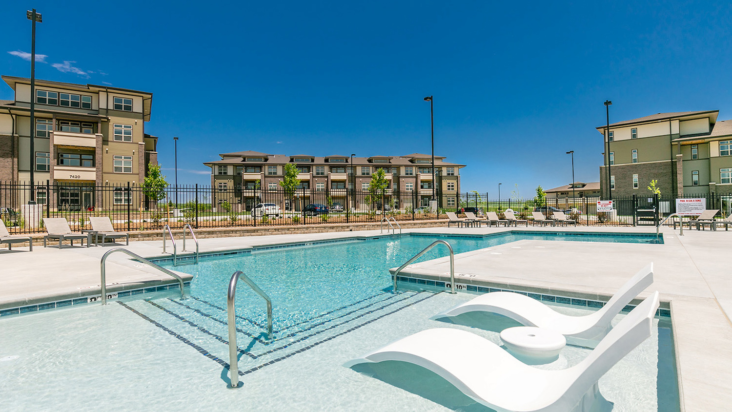 Pool view of a large apartment community.