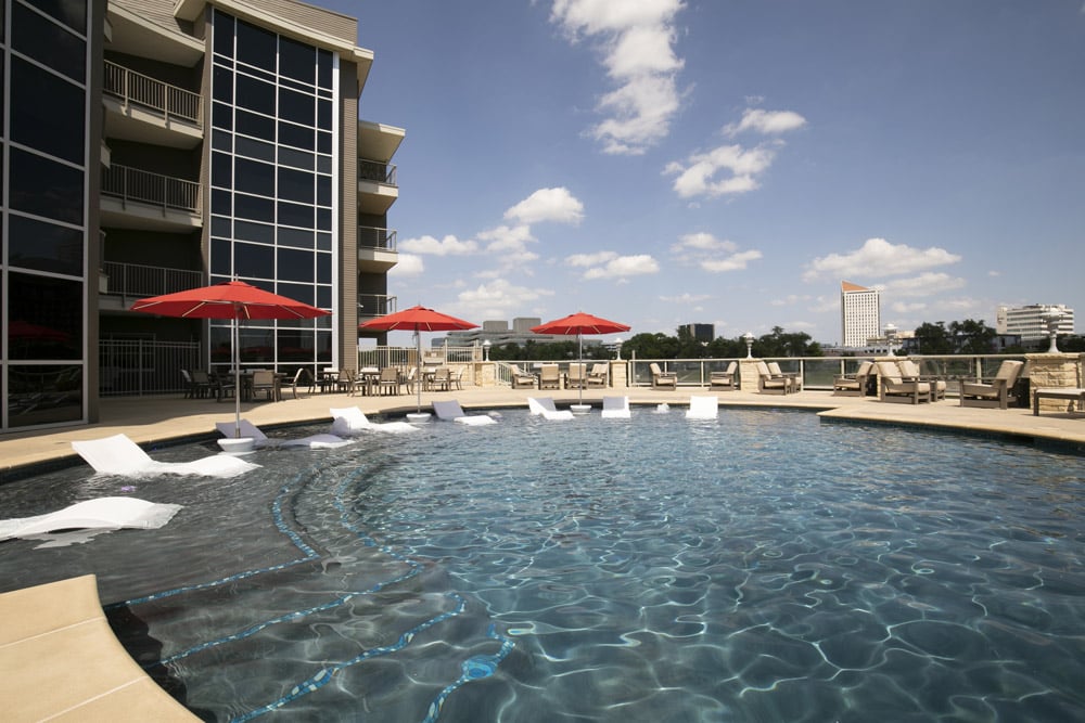 Community pool and lounge area before editing with shadowed lighting